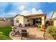 Charming backyard with a covered patio, low-maintenance artificial grass, and cozy seating area at 10657 E Texas Ave, Mesa, AZ 85212