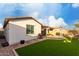 Well-maintained backyard featuring an artificial lawn, extended brick patio, and convenient BBQ area at 10657 E Texas Ave, Mesa, AZ 85212