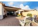 Inviting backyard with paved patio, comfortable seating, covered area, and lush green landscaping at 10657 E Texas Ave, Mesa, AZ 85212