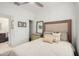 Well-lit bedroom showcasing a queen bed, dresser, closet, neutral tones, and stylish decor at 10657 E Texas Ave, Mesa, AZ 85212