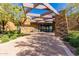 Stately clubhouse entrance with stone accents, architectural details, and lush greenery, creating an elegant impression at 10657 E Texas Ave, Mesa, AZ 85212