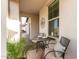 Inviting front porch with a cozy seating area overlooking the beautiful community landscape at 10657 E Texas Ave, Mesa, AZ 85212