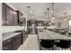 Well-equipped kitchen featuring dark cabinets, stainless steel appliances, granite countertops, and a large center island at 10657 E Texas Ave, Mesa, AZ 85212