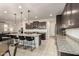 Spacious open kitchen with large island, breakfast bar, granite countertops, and stainless steel appliances at 10657 E Texas Ave, Mesa, AZ 85212