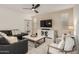Cozy living room with modern furniture and a ceiling fan, perfect for relaxation and entertainment at 10657 E Texas Ave, Mesa, AZ 85212
