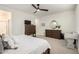 Spacious main bedroom with a ceiling fan, dresser, and sitting area at 10657 E Texas Ave, Mesa, AZ 85212