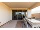 Spacious covered patio featuring a dining table, chairs, brick flooring and sliding glass doors at 10657 E Texas Ave, Mesa, AZ 85212
