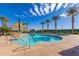 Resort-style community pool featuring clear water, ample seating, and beautiful palm trees at 10657 E Texas Ave, Mesa, AZ 85212