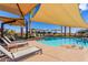 Community pool with plenty of shaded seating and lounge chairs at 10657 E Texas Ave, Mesa, AZ 85212