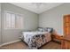 Cozy bedroom with a floral-themed comforter and a large window for natural light at 10718 E Secret Canyon Rd, Gold Canyon, AZ 85118