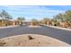 Gated community entrance with lush landscaping and mature trees at 10718 E Secret Canyon Rd, Gold Canyon, AZ 85118