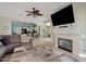 Open-concept living room with fireplace and a ceiling fan connecting to the kitchen and dining area at 10718 E Secret Canyon Rd, Gold Canyon, AZ 85118