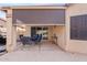 Covered patio with a retractable screen, dining table, and comfortable seating at 10718 E Secret Canyon Rd, Gold Canyon, AZ 85118