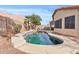 Inviting backyard pool with lush landscaping and a clear blue sky at 10718 E Secret Canyon Rd, Gold Canyon, AZ 85118