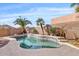 Inviting outdoor pool featuring lush landscaping and mature palm trees under a sunny sky at 10718 E Secret Canyon Rd, Gold Canyon, AZ 85118