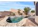 Inviting backyard pool with lush landscaping, surrounded by rocks at 10718 E Secret Canyon Rd, Gold Canyon, AZ 85118