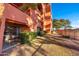 View of the back patio with table and chairs, green hedges, and rod iron fence at 12212 N Paradise Village S Pkwy # 129, Phoenix, AZ 85032