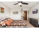 Cozy bedroom featuring ceiling fan, comfortable bed, and stylish dresser at 12212 N Paradise Village S Pkwy # 129, Phoenix, AZ 85032