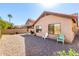 View of the home's backyard featuring gravel, a covered patio with a grill, and outdoor seating at 1344 W Seascape Dr, Gilbert, AZ 85233