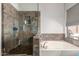 Bathroom showcasing a soaking tub, glass enclosed shower with stylish tile, and a window at 1344 W Seascape Dr, Gilbert, AZ 85233
