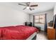 Bedroom featuring wood-look flooring, a ceiling fan, and a window for natural light at 1344 W Seascape Dr, Gilbert, AZ 85233