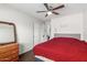 Bedroom showcasing wood-look flooring, a ceiling fan, a closet with sliding doors, and furnishings at 1344 W Seascape Dr, Gilbert, AZ 85233