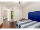 Bedroom with wood-look floors and a view to the ensuite bathroom and closet with sliding doors at 1344 W Seascape Dr, Gilbert, AZ 85233