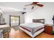 Bright bedroom has hardwood floors, neutral walls, ceiling fan, and large window at 1344 W Seascape Dr, Gilbert, AZ 85233