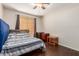 Bedroom with hardwood floors, ceiling fan, neutral walls, and large window at 1344 W Seascape Dr, Gilbert, AZ 85233