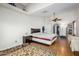Bright primary bedroom features hardwood floors, ceiling fan, and neutral walls at 1344 W Seascape Dr, Gilbert, AZ 85233