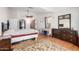 Spacious primary bedroom with hardwood floors, ceiling fan, and neutral walls at 1344 W Seascape Dr, Gilbert, AZ 85233