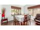 Cozy dining area with seating for six, wood flooring, and a large window offering a view of the outside at 1344 W Seascape Dr, Gilbert, AZ 85233