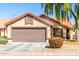 Charming single-story home featuring a terracotta roof, desert landscaping and an attached two-car garage at 1344 W Seascape Dr, Gilbert, AZ 85233