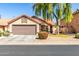 Charming single-story home with desert landscaping, a two-car garage, and a red tile roof at 1344 W Seascape Dr, Gilbert, AZ 85233