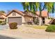 Charming single-story home with a low-maintenance front yard and an attached two-car garage at 1344 W Seascape Dr, Gilbert, AZ 85233