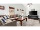 Inviting living area with a large sectional sofa, a soft rug, and a view of the front door and television at 1344 W Seascape Dr, Gilbert, AZ 85233