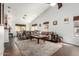 Bright and airy living room featuring vaulted ceilings, wood floors, a large sofa, and an adjacent dining area at 1344 W Seascape Dr, Gilbert, AZ 85233