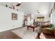 Cozy living room with plush carpeting, lots of natural light, and an open layout flowing into the kitchen at 1344 W Seascape Dr, Gilbert, AZ 85233