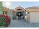 Inviting home entrance with a charming gated courtyard, desert landscaping, and stone accents at 14741 E Mountain Majesty --, Fountain Hills, AZ 85268