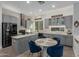Modern kitchen with stainless steel appliances, an island, gray cabinets, and a stylish breakfast nook with blue chairs at 14741 E Mountain Majesty --, Fountain Hills, AZ 85268