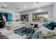 Spacious living room with bright windows, plush seating, and teal accents, offering a comfortable gathering space at 14741 E Mountain Majesty --, Fountain Hills, AZ 85268