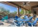 Inviting outdoor patio with blue chairs, fan, fireplace, creating perfect entertaining area at 14741 E Mountain Majesty --, Fountain Hills, AZ 85268