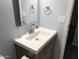 Bathroom vanity features a modern sink, faucet, wood cabinet, and a well-lit mirror at 15402 N 28Th St # 112, Phoenix, AZ 85032