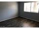Bedroom boasts stylish wood-look floors and a window with blinds for ample natural light at 15402 N 28Th St # 112, Phoenix, AZ 85032