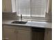 Well-lit kitchen features quartz countertops, stainless steel appliances, and white cabinetry under a window at 15402 N 28Th St # 112, Phoenix, AZ 85032