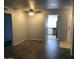 Open living room showcases wood-style floors and provides a view to the kitchen and entry at 15402 N 28Th St # 112, Phoenix, AZ 85032