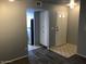 Inviting living room with wood-style floors offers an open view to the kitchen and front door at 15402 N 28Th St # 112, Phoenix, AZ 85032