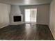 Open living room features wood-style flooring, a fireplace, and sliding door access to the outdoor space at 15402 N 28Th St # 112, Phoenix, AZ 85032
