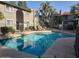Community pool with lounge chairs and nearby apartment buildings for a relaxing outdoor experience at 15402 N 28Th St # 112, Phoenix, AZ 85032