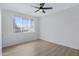 Bright bedroom with a ceiling fan, wood floors, and a large window at 16013 S Desert Foothills Pkwy # 1133, Phoenix, AZ 85048